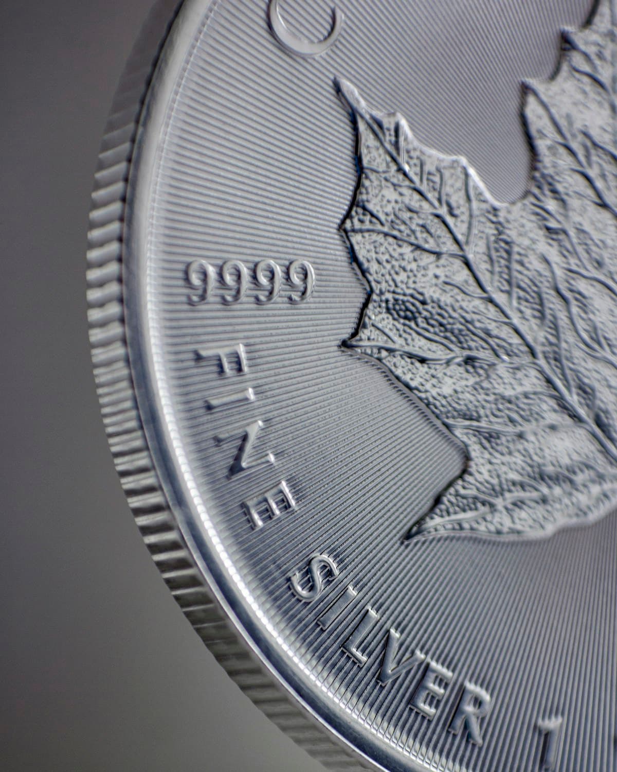 A fine silver coin photographed in close detail, showing crisp engraved lettering
