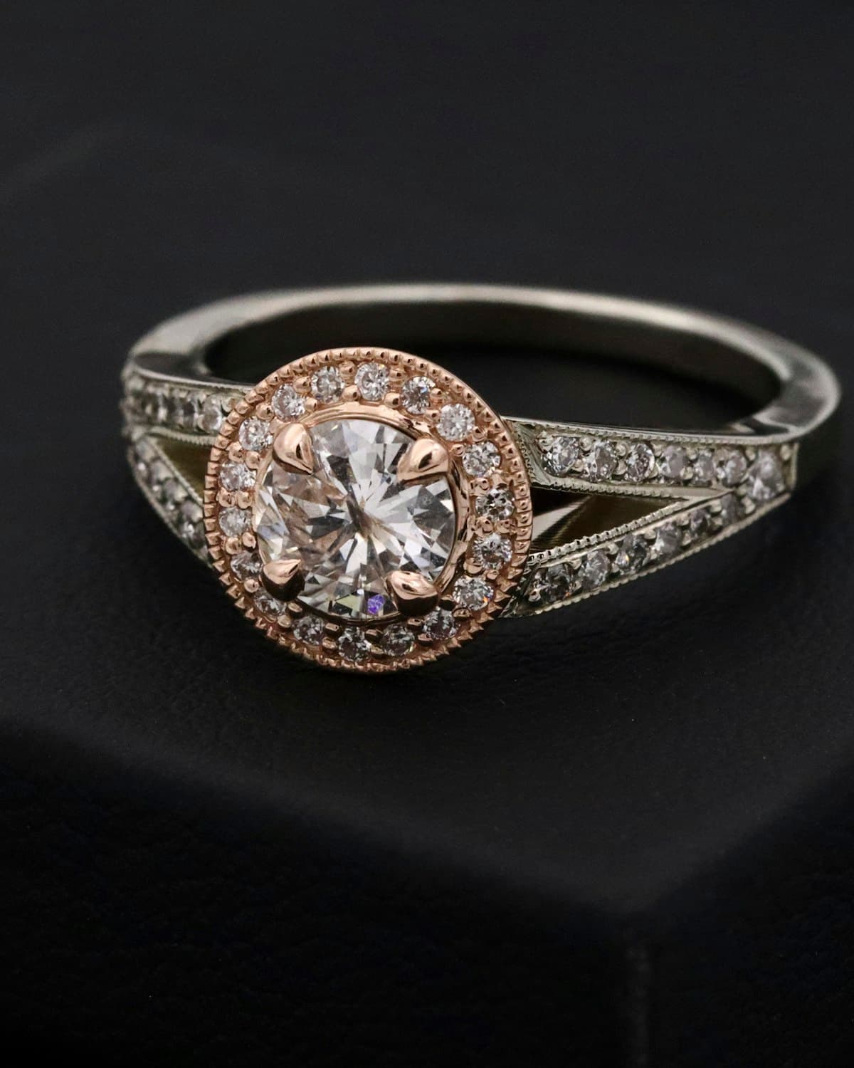 A fine diamond ring under soft case light at the counter